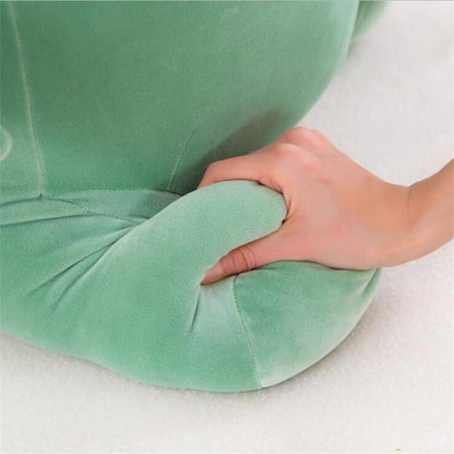 Octoplush Kawaii collection green dinosaur plushie close-up, being squeezed to demonstrate its soft and squishable velvet-like fabric. This premium dino stuffed animal from Octoplush.store features a high-density, marshmallow-soft filling, making it the perfect durable and cuddly choice for kawaii room decor and sensory gifts.