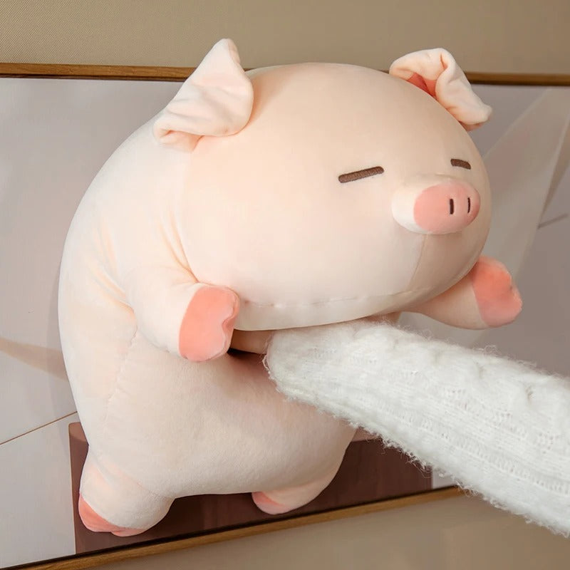 A hand squeezing a pink kawaii piggy squishy plush to demonstrate its super-soft, mochi-like texture and resilience.