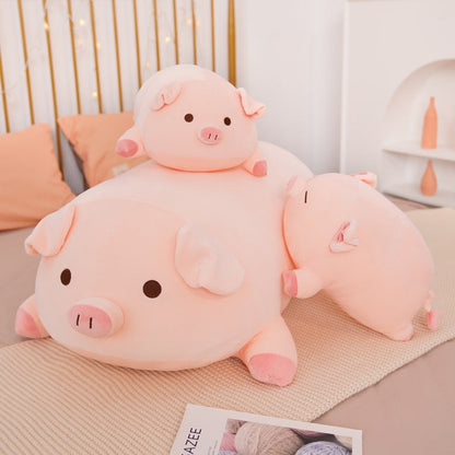 A cute stack of three pink kawaii squishy piggy plushies in varying sizes arranged as aesthetic bed pillows.