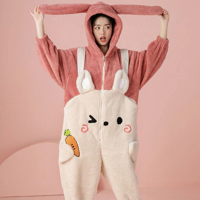 Adult pink bunny onesie in cozy fleece, featuring a fun rabbit kigurumi design with floppy ears and carrot details. Perfect for lounging