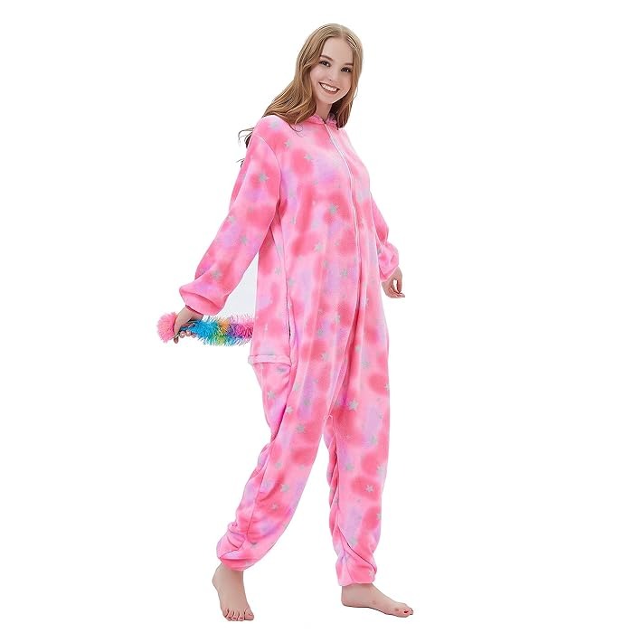 Side view of pink unicorn onesie showing rainbow tail and zip-up fleece design.